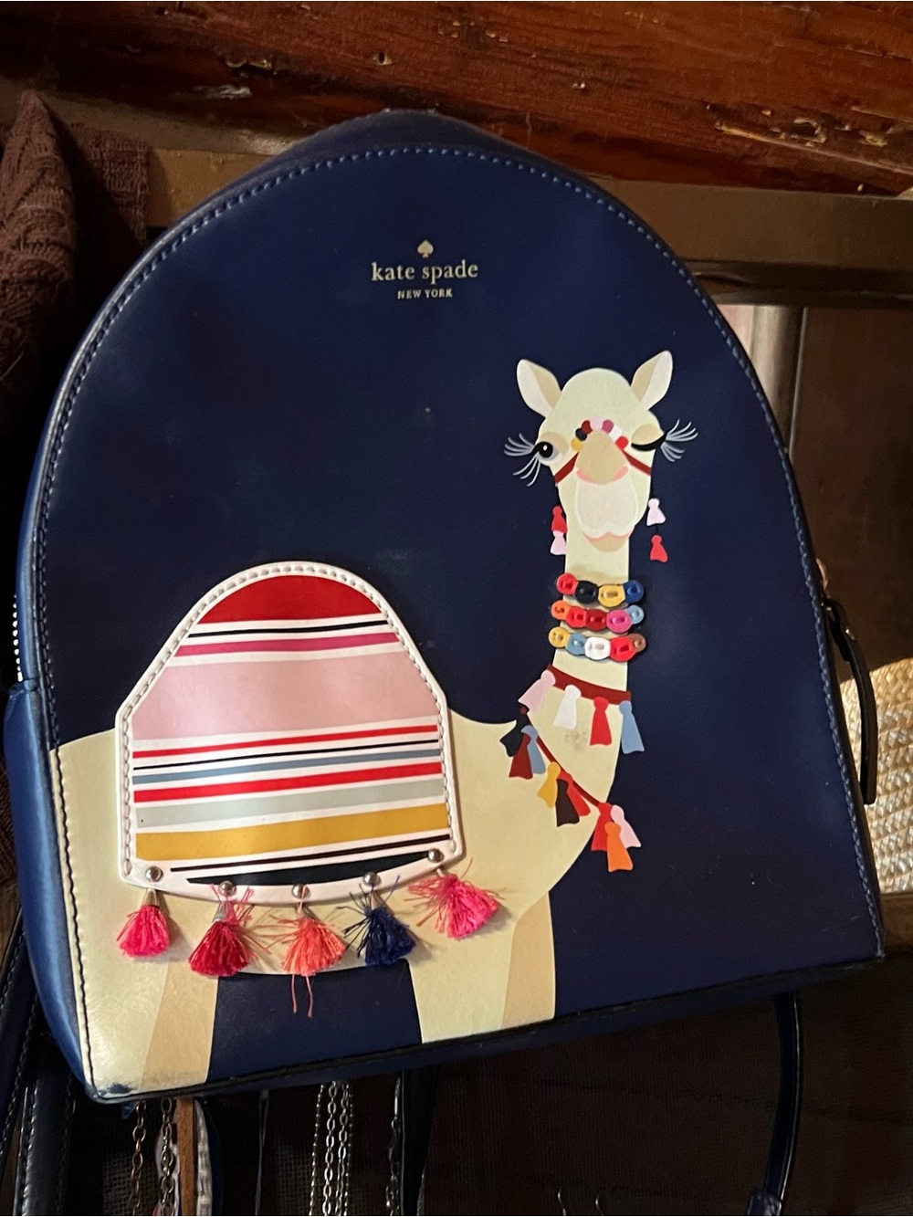 kate spade navy backpack with cream llama and multicolor tassels